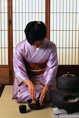 Japanese woman performing tea ceremony in seiza sitting position Japanese woman performing tea ceremony in seiza sitting position