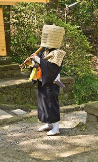 A Buddhist monk begging as a komusō A Buddhist monk begging as a komusō